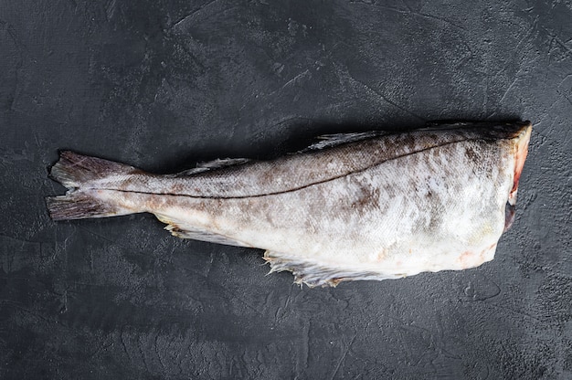 Fresh haddock fish carcass. Black background. Top view