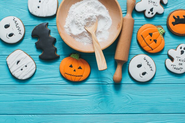 Fresh halloween gingerbread cookies on blue wooden table.