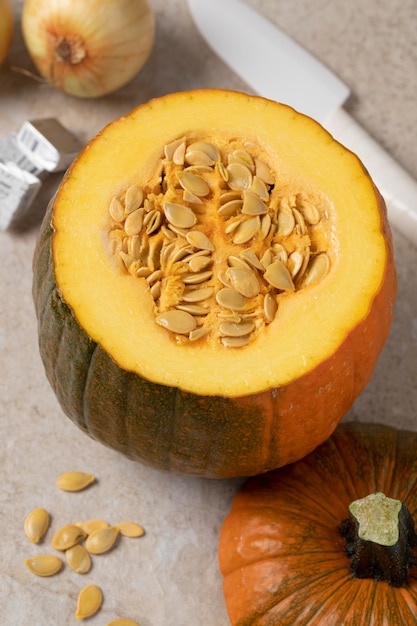 Fresh halloween pumpkin and a cut seen from above close up on a cutting board