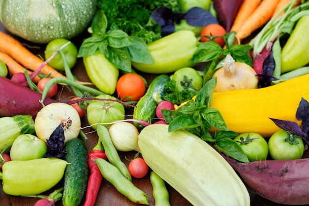 Fresh Harvest from the Gardens on Wooden chalkboard from above.