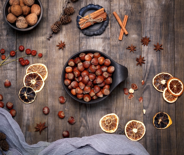 Fresh hazelnuts in a shell in a brown plate