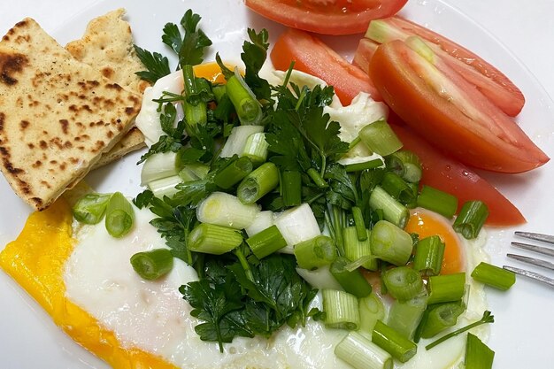 Fresh healthy food with greens on plates close view