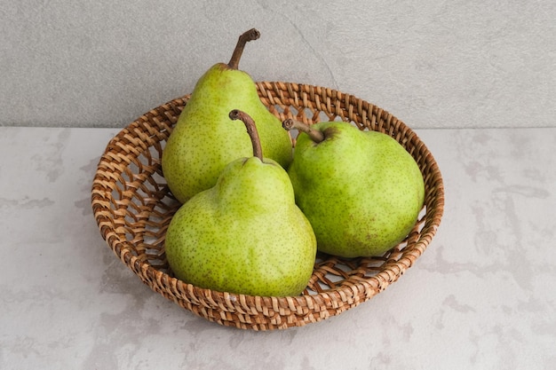 Fresh and healthy green pear fruits on grey background Close up selected focus