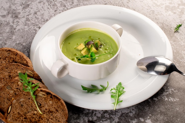 Fresh healthy green spinach cream soup Vegan cuisine