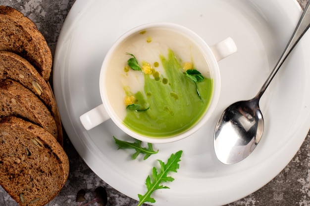 Fresh healthy green spinach cream soup vegan cuisine