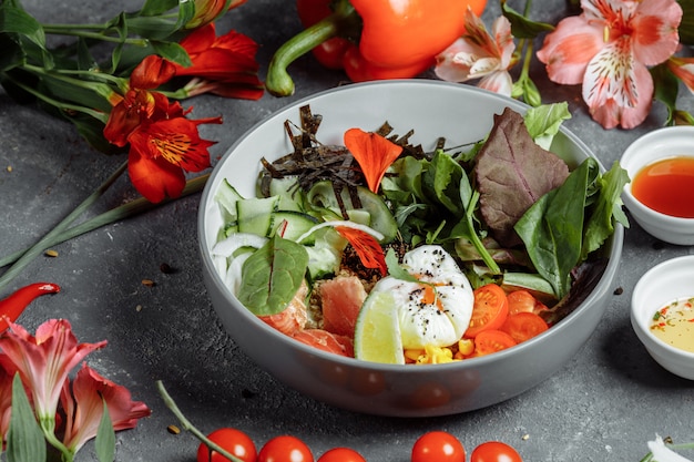 Fresh healthy light breakfast, business lunch. Breakfast with poached egg, buckwheat, red fish, fresh salad, cucumbers and cherry tomatoes, business lunch concept