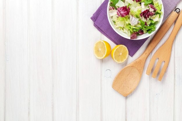 Fresh healthy salad and kitchen utensils