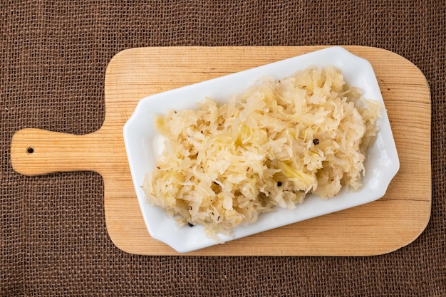 Fresh healthy sauerkraut on white plate