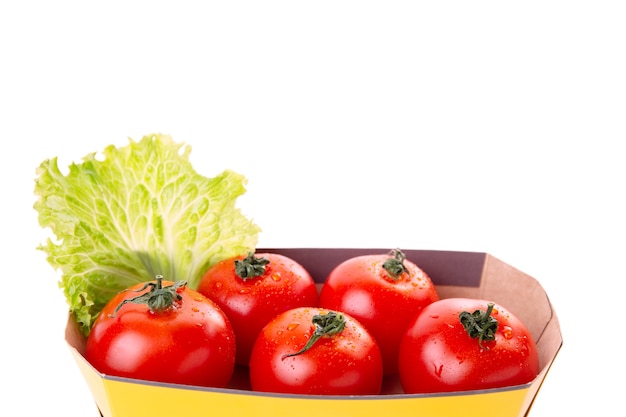 Fresh healthy tomatoes in an eco bag isolated on a white background. Shopping of organic and vegetarian food. Zero waste, eco friendly or plastic free lifestyle concept. Copy space.