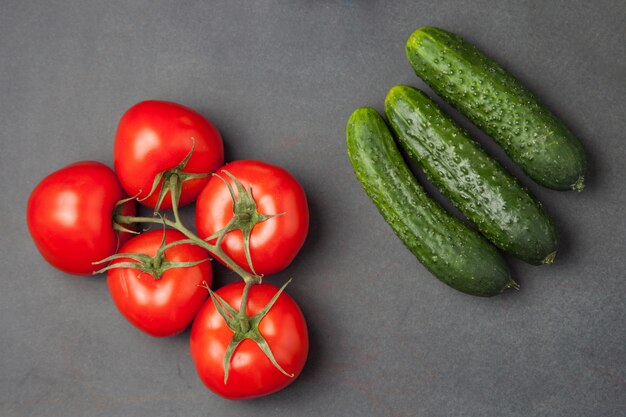 Fresh healthy vegetables - cucumber and tomatoes. Top view.