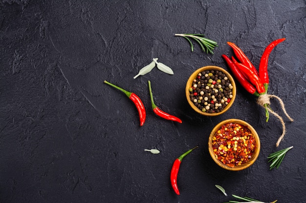 Fresh herbs and spices on black stone table