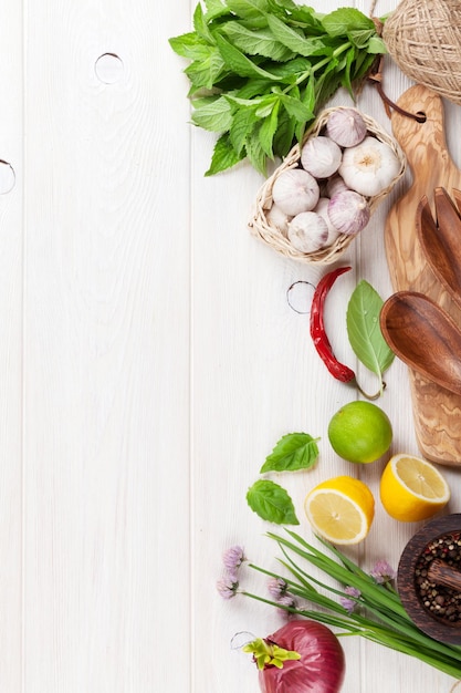 Fresh herbs and spices on wooden table