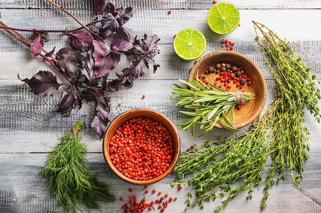 Fresh herbs with spices on wooden