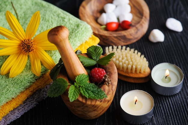 Fresh herbs in wooden mortar and spa set