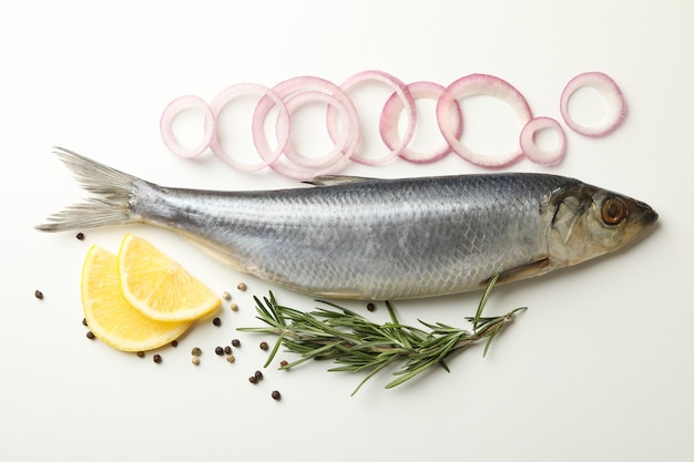 Fresh herring fish and spices on white background