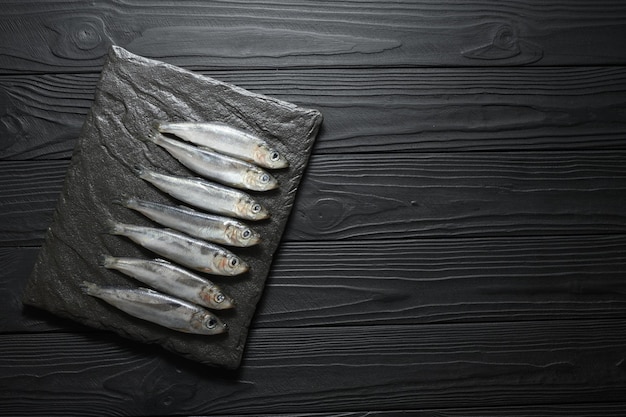 Photo fresh herring on rustic wooden background close up shot