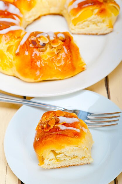 Fresh home baked sweet bread donut cake with almonds and icing sugar on top