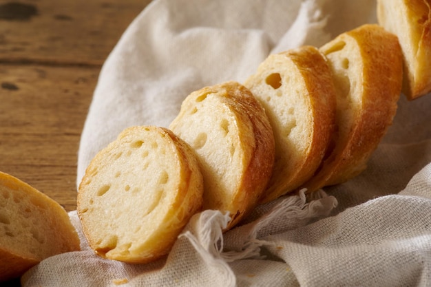 Fresh homemade baguette on a wooden background