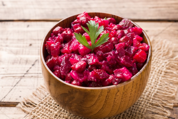 Fresh homemade beet salad vinaigrette in a wooden bowl. Traditional Russian food.