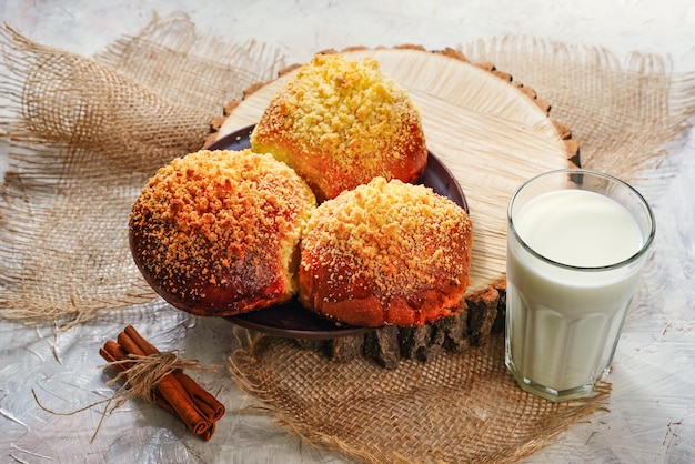 Fresh homemade bread buns for breakfast with milk rustic style