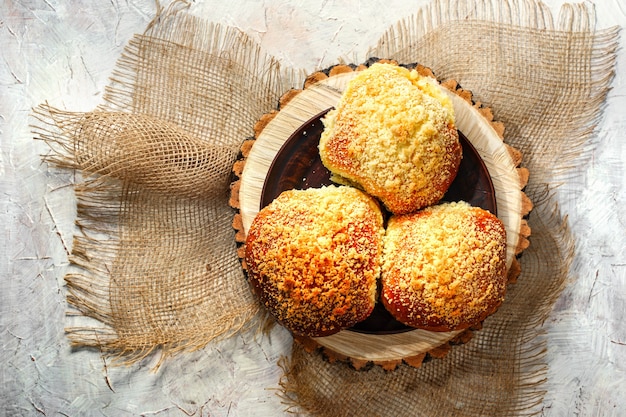 Fresh homemade bread rolls with sesam seeds on wooden table