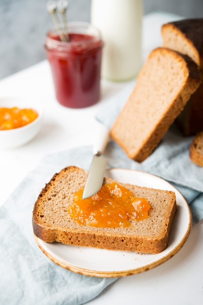 Fresh homemade bread with jam and milk, homemade simple food