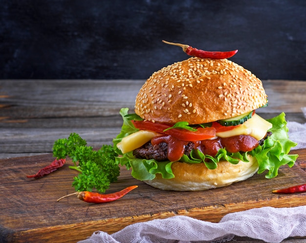 Fresh homemade burger with lettuce, cheese, onion and tomato 