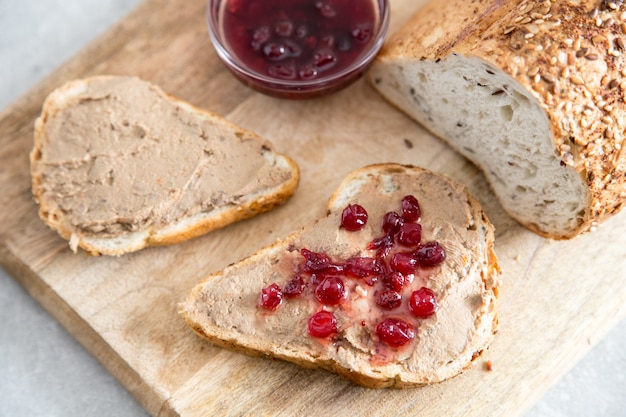 Fresh homemade chicken liver pate (rabbit, goose) with cranberry sauce. Toasted bread with pate