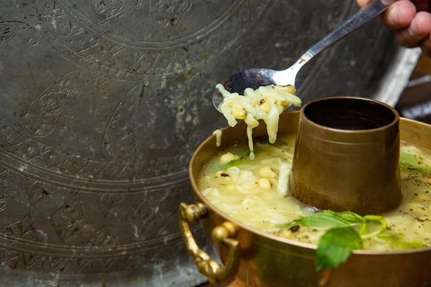 Fresh homemade chicken soup with noodle at table