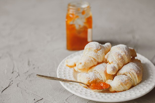 Fresh homemade croissants with apricot jam