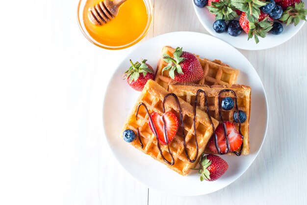 Fresh homemade food of berry Belgian waffles with honey