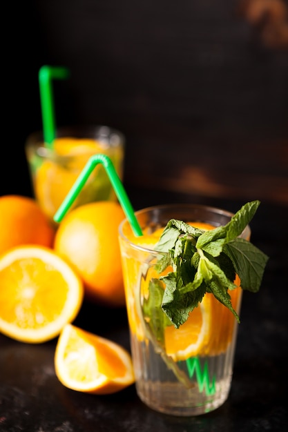 Fresh homemade healthy and delicious orangeade on vintage wooden background