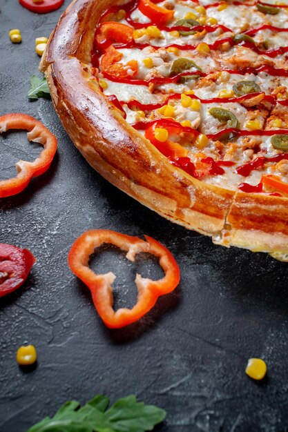 Fresh Homemade Italian Pizza Margherita with olives and red Bulgarian peppers on a dark background