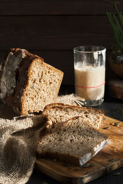 Fresh homemade leavened bread in the sun, partially sliced