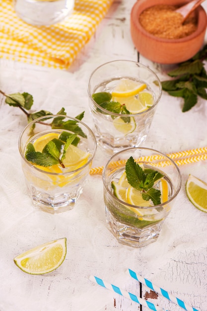 Fresh homemade lemon and lime lemonade served with mint, ice cubes and straws 