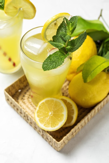 Fresh Homemade Lemonade or mojito cocktail with lemon mint and ice