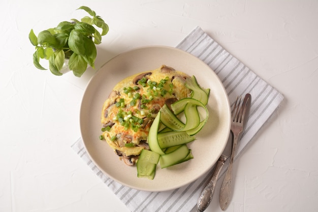 Fresh homemade omelet with mushrooms green fresh onion and herbs