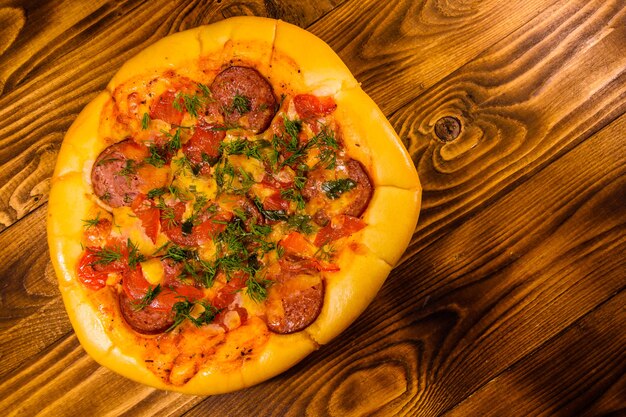 Fresh homemade pizza on rustic wooden table. Top view