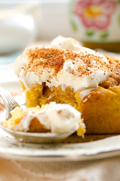 Fresh homemade pumpkin cinnamon rolls with spices and sweet cream