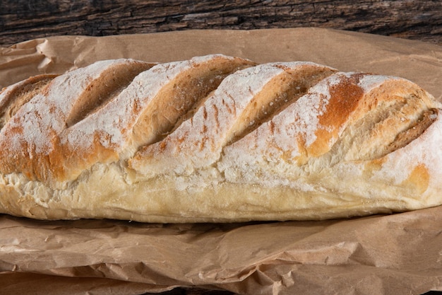 Fresh homemade rustic sourdough bread on a rustic wood background