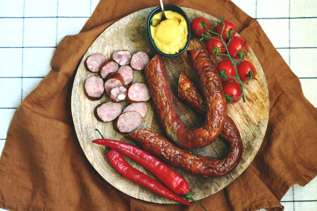 Fresh homemade sausages on a wooden tray