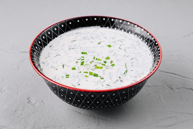 fresh homemade tzatziki sauce or cold soup okroshka in decorative bowl
