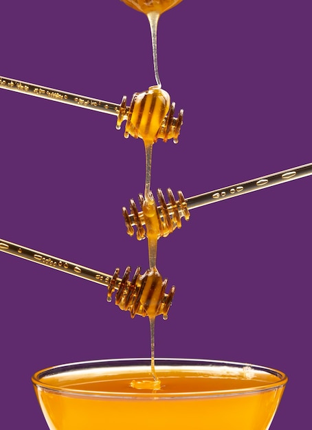 Fresh honey drips from a spoon into a plate organic vitamin health food