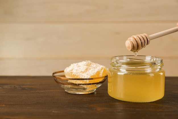 fresh honey is on wooden background