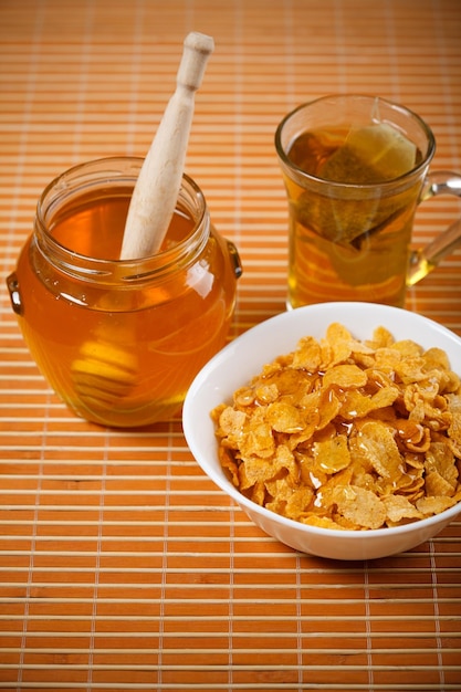 fresh honey, tea and breakfast flakes