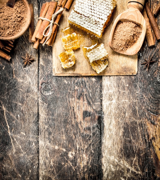 Fresh honey with cinnamon. On wooden background.