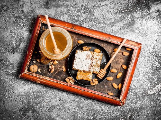 Fresh honey with nuts. On rustic table.