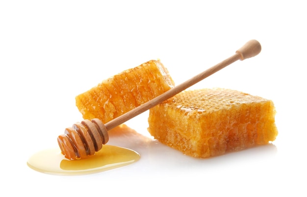 Fresh honeycombs with dipper on white background