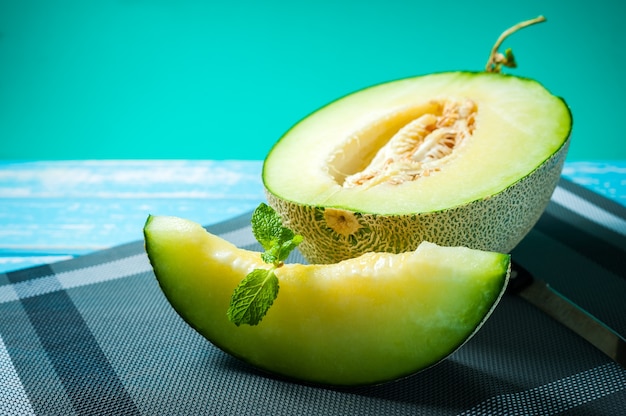 Fresh Honeydew melon on wooden table, healthy food.