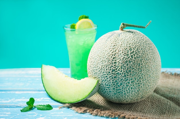 Fresh Honeydew melon on wooden table, healthy food.